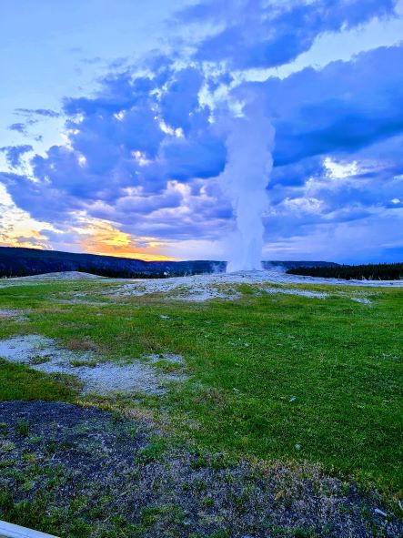 Old Faithful at sunset during a multi-generational family vacation