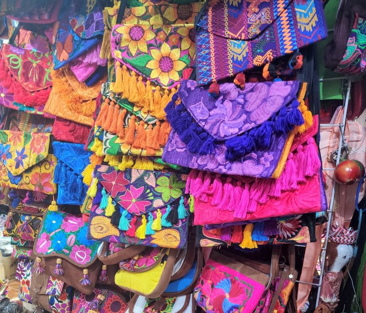 Display of colorful purses at Benito Juarez market in Oaxaca
