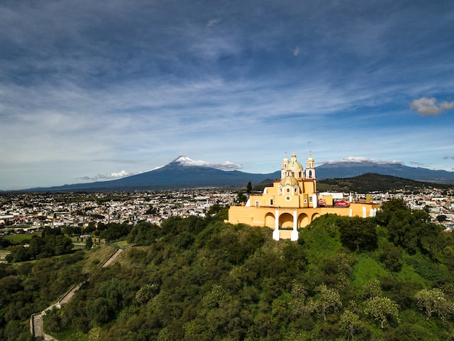 Panoramic view of the Great Pyramid, church and volcano in the distance